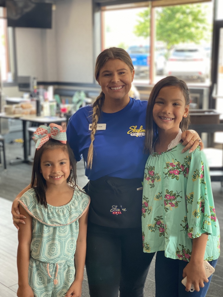 a lady and two kids smiling