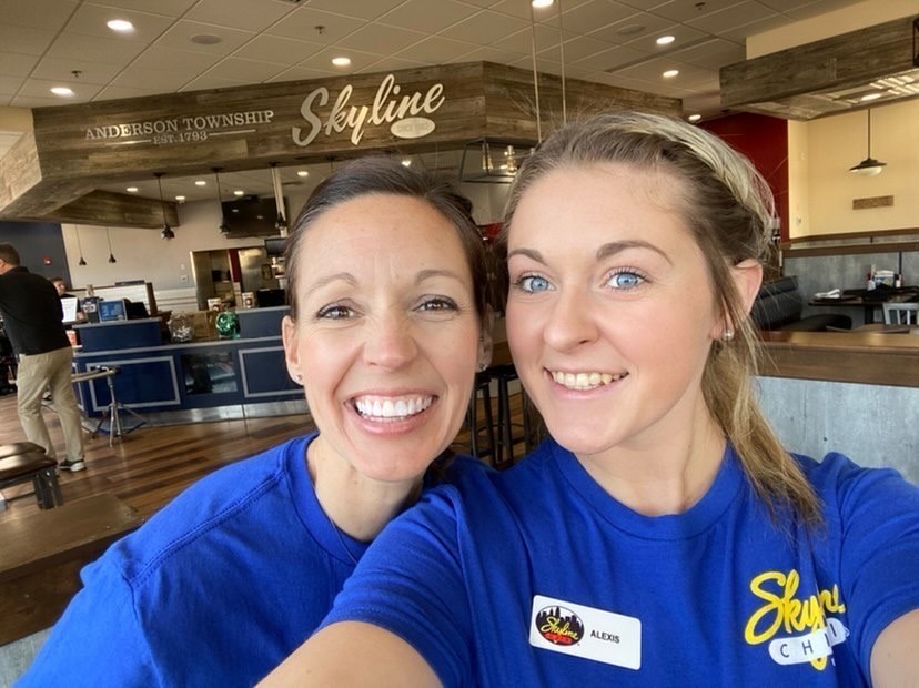 two employees smiling