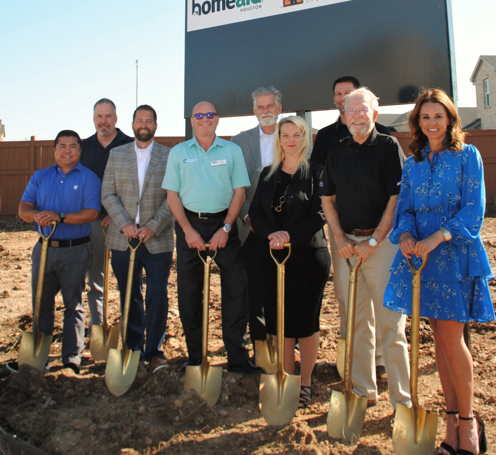 Picture of people holding shovels at a new construction site
