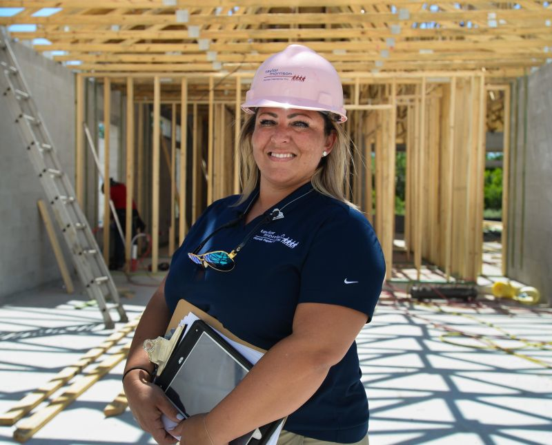 woman smiling wearing a hard hat