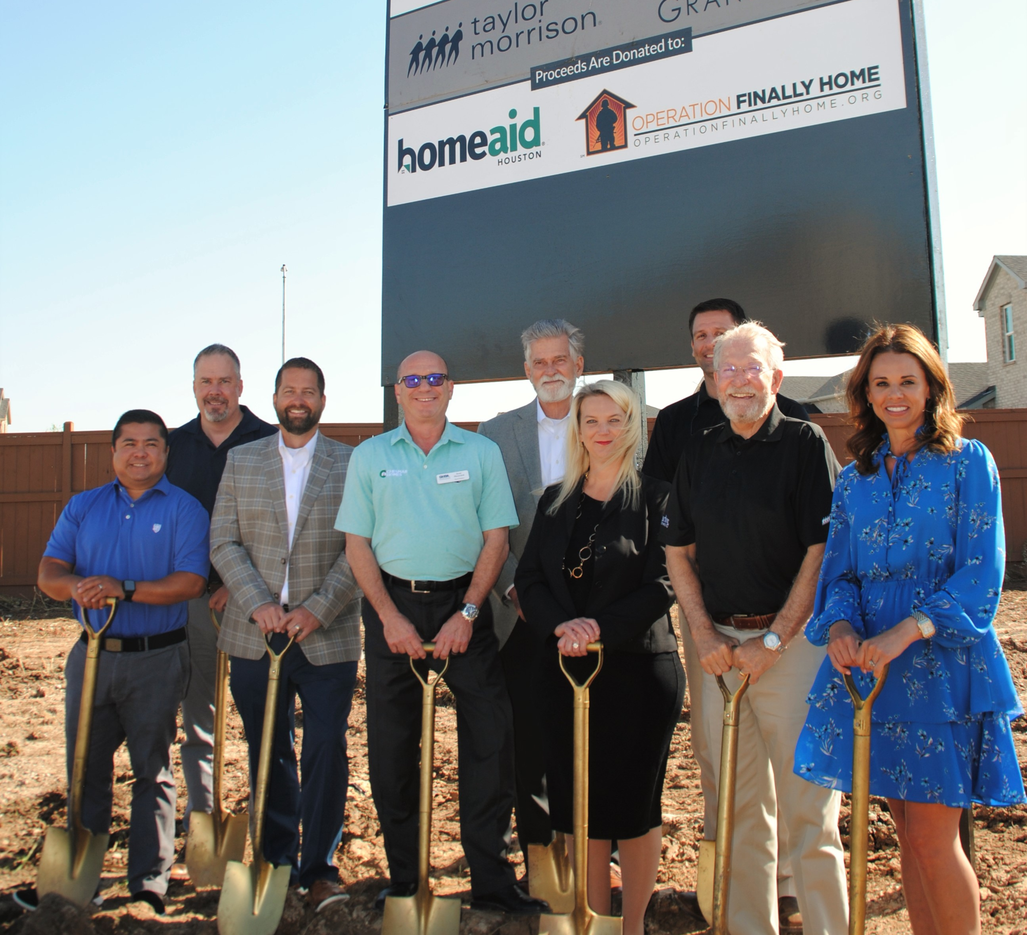 team at a ground breaking holding shovels