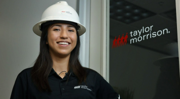 woman smiling wearing a hardhat