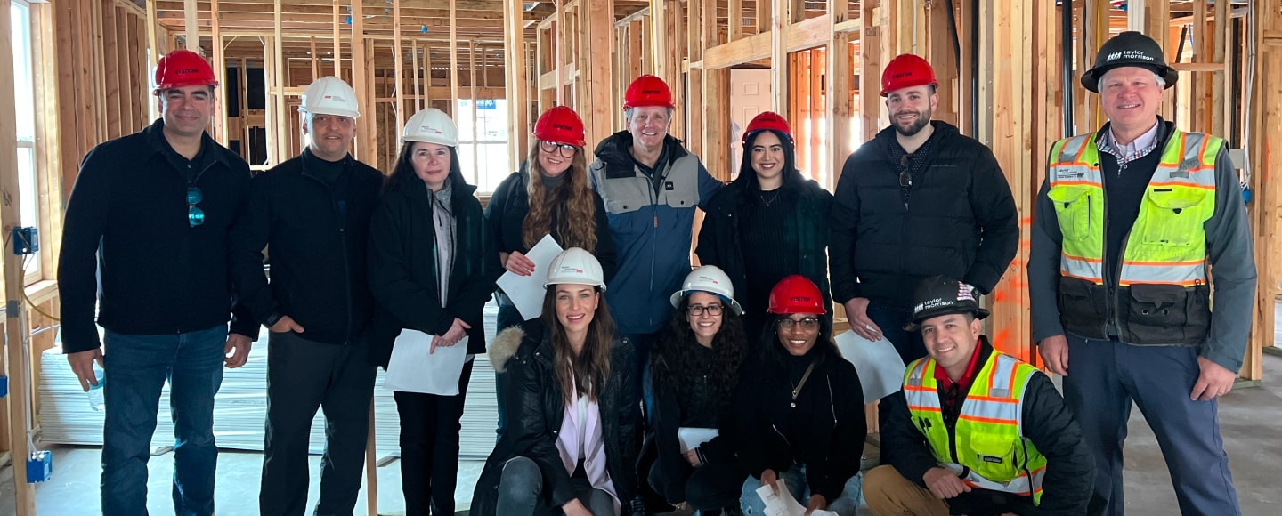 people wearing hardhats inside of a home under construction