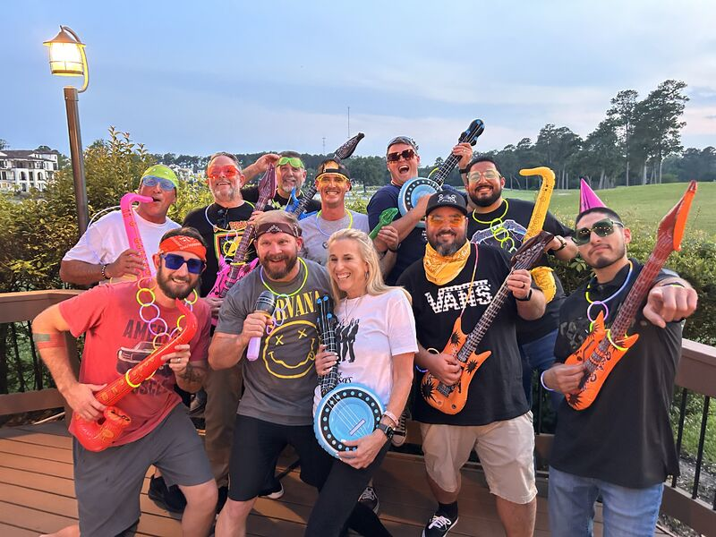 group picture of the team holding musical instruments