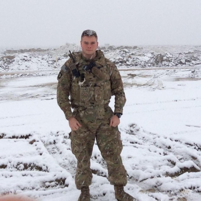 man standingin snow in a military uniform
