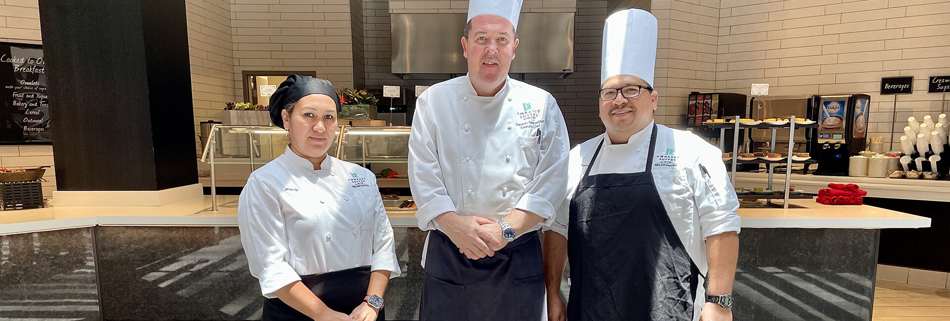 three employees smiling