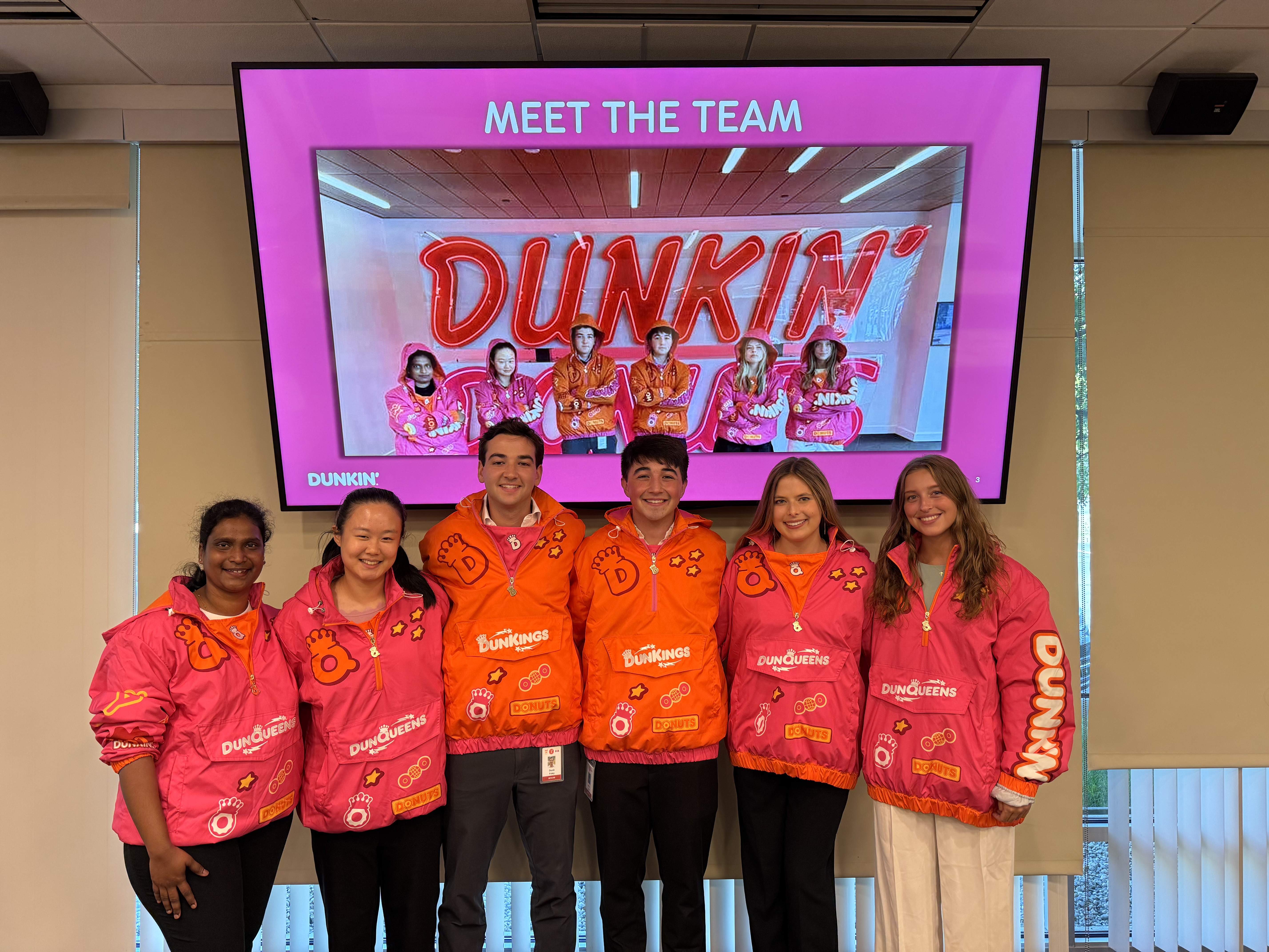 group of people holding an Inspire logo banner