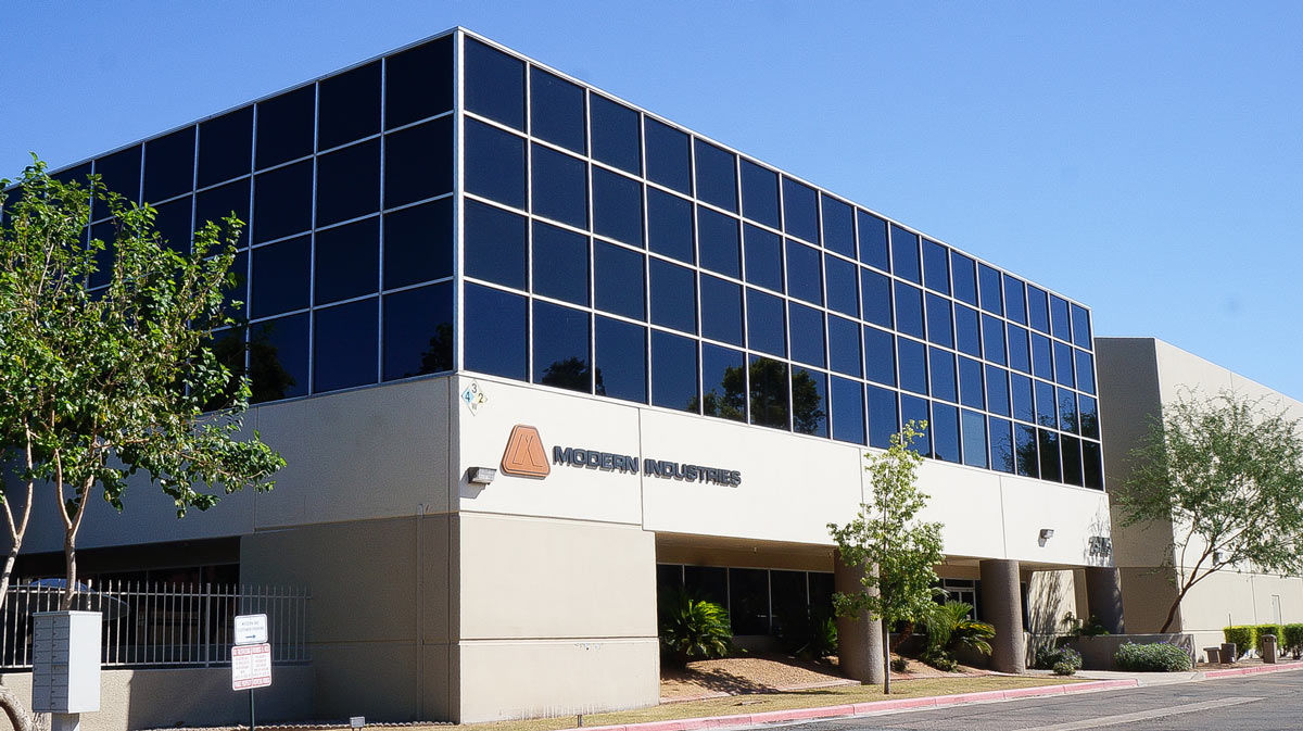 front of modern industries office building