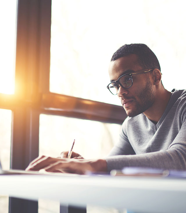 Man staring intently at computer screen