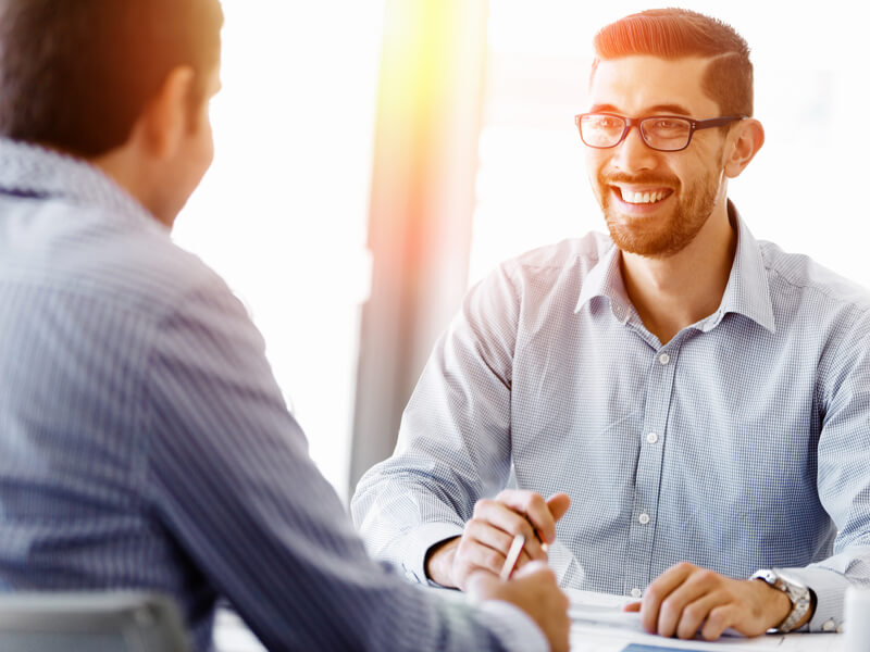 Smiling man in one on one meeting