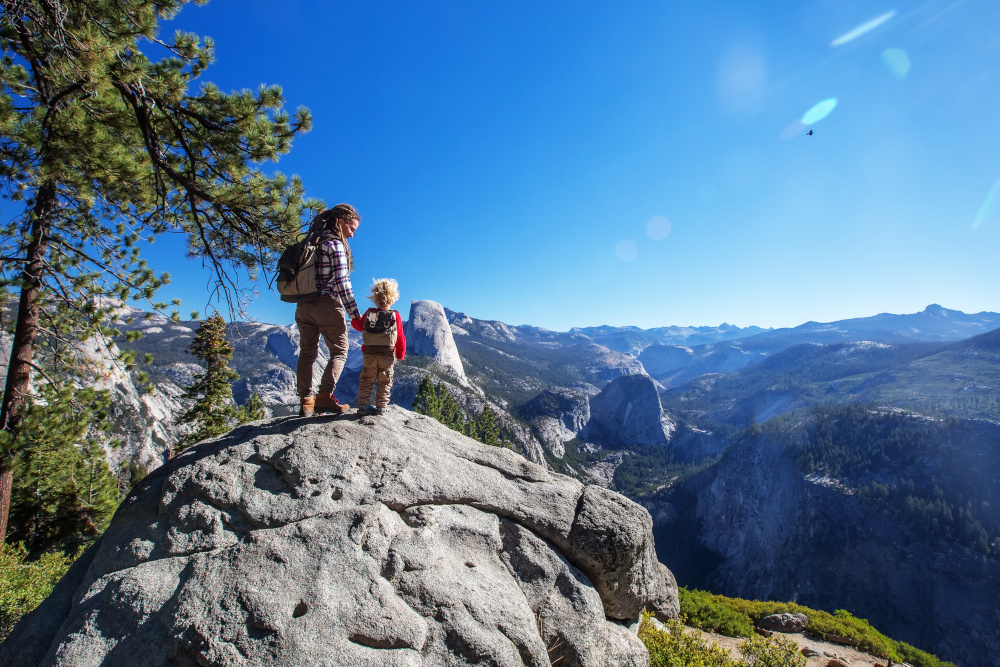 picture of an adult and child looking at the mountains