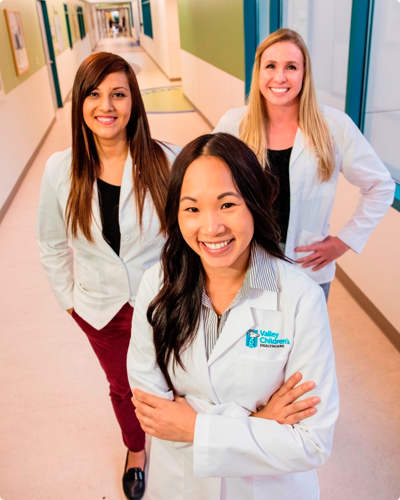 three employees smiling