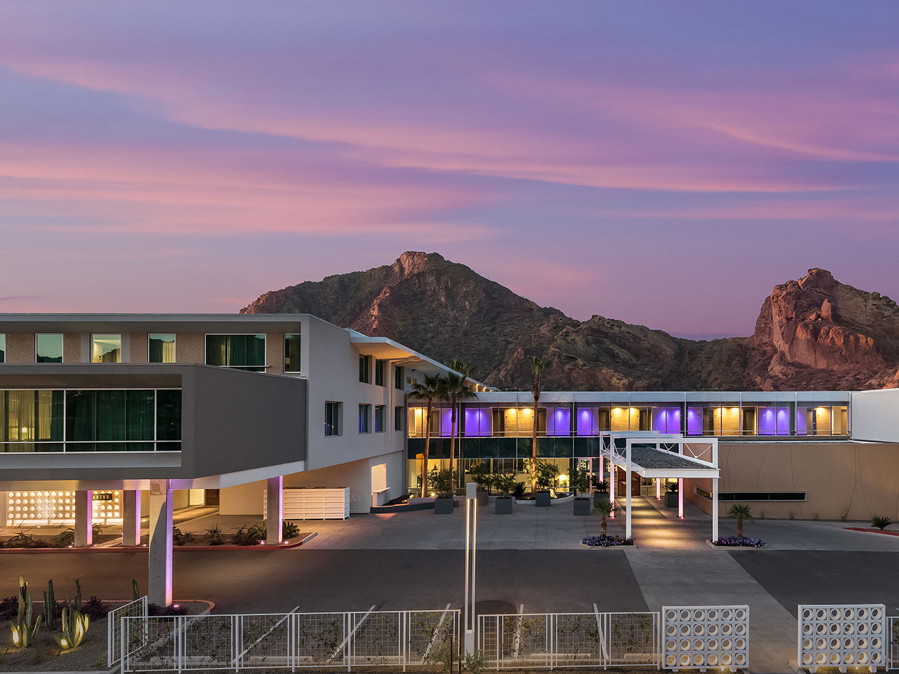 evening photo of resort with mountains in the background