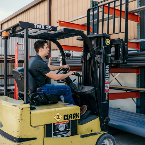 man working on a forklift