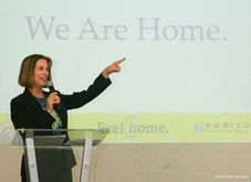 woman speaking at a lecturn