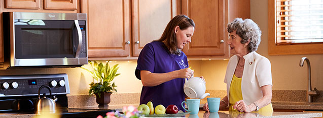 two women standing in a kitchen