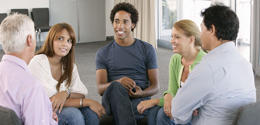 five people sitting in a circle