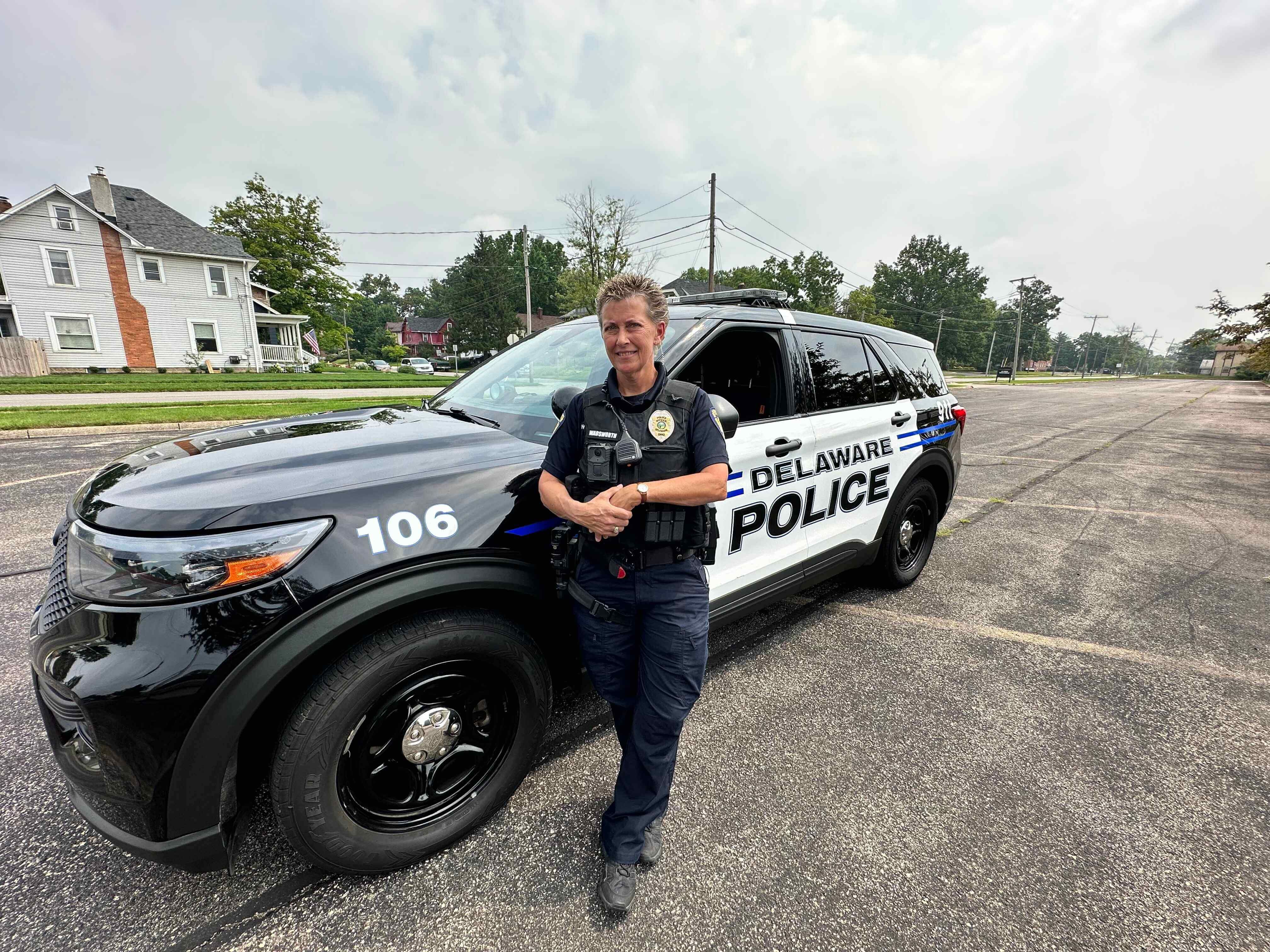 A male police officer was laughing and joking with the children