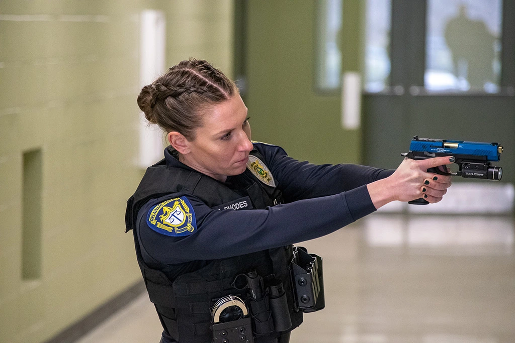 A female police officer is wearing a helmet