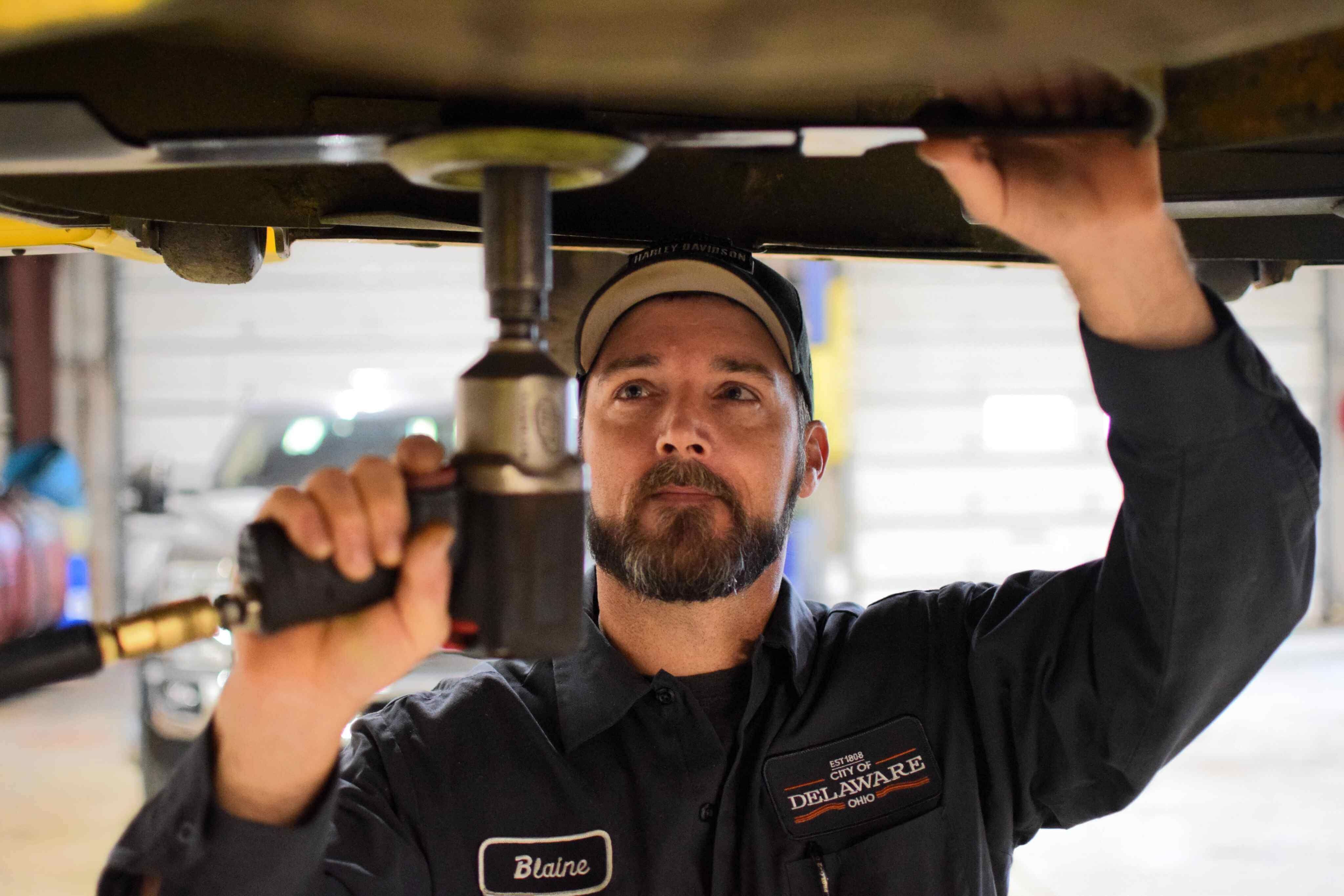 The man is repairing a car