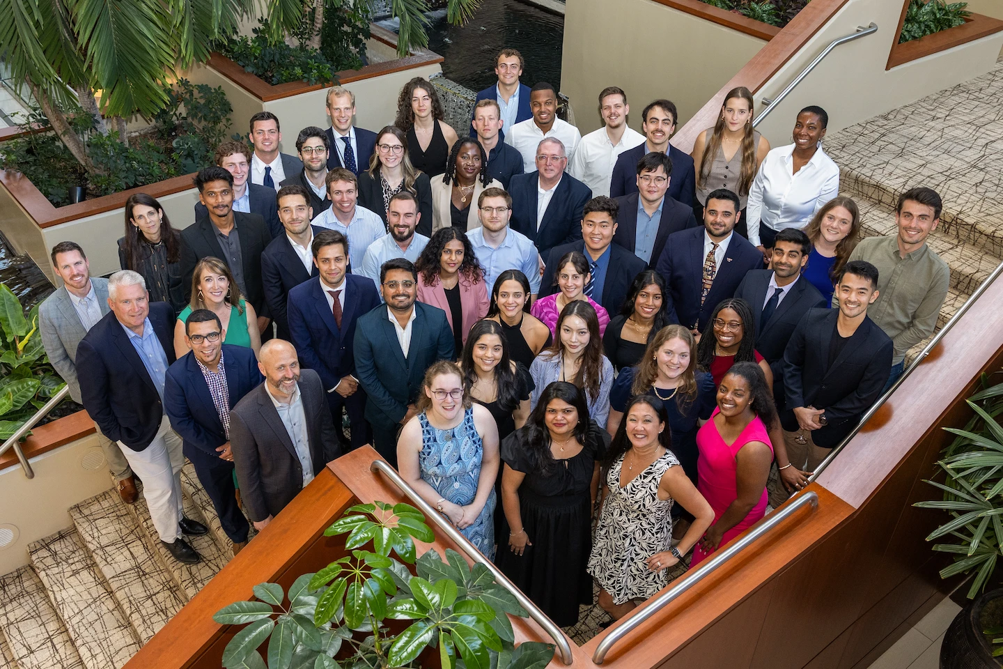 A group of people pose for a photo looking up at the photographer