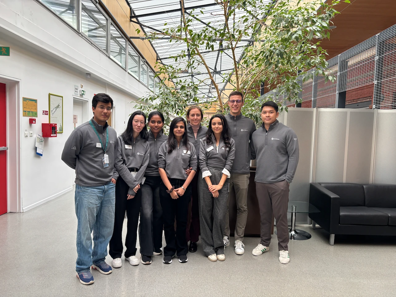 A group of people pose for a photo inside of an office