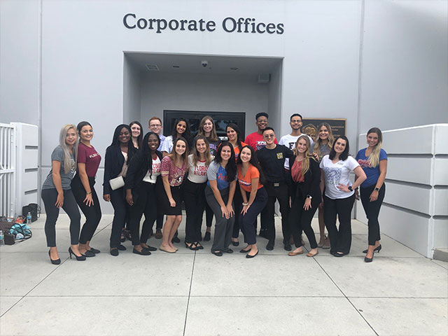 Picture of interns in front of a building