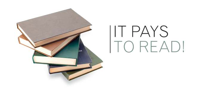 it pays to read banner next to a pile of books
