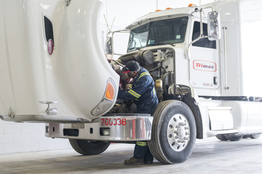 shop employee working on truck