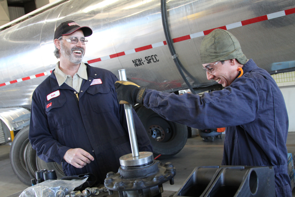 two employees smiling and working