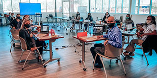 people in a classroom setting wearing masks
