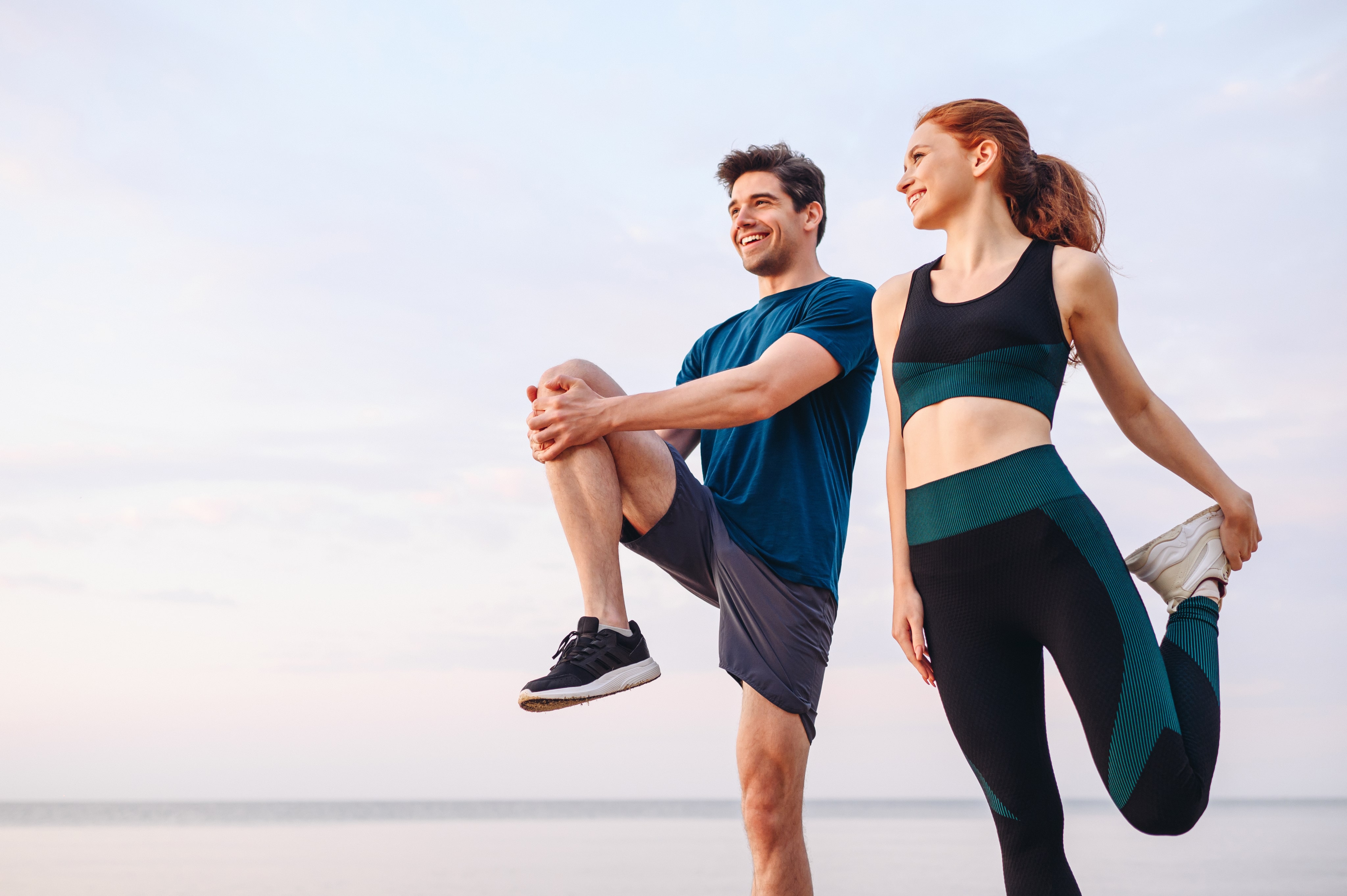 A woman and a man working out in the morning outside