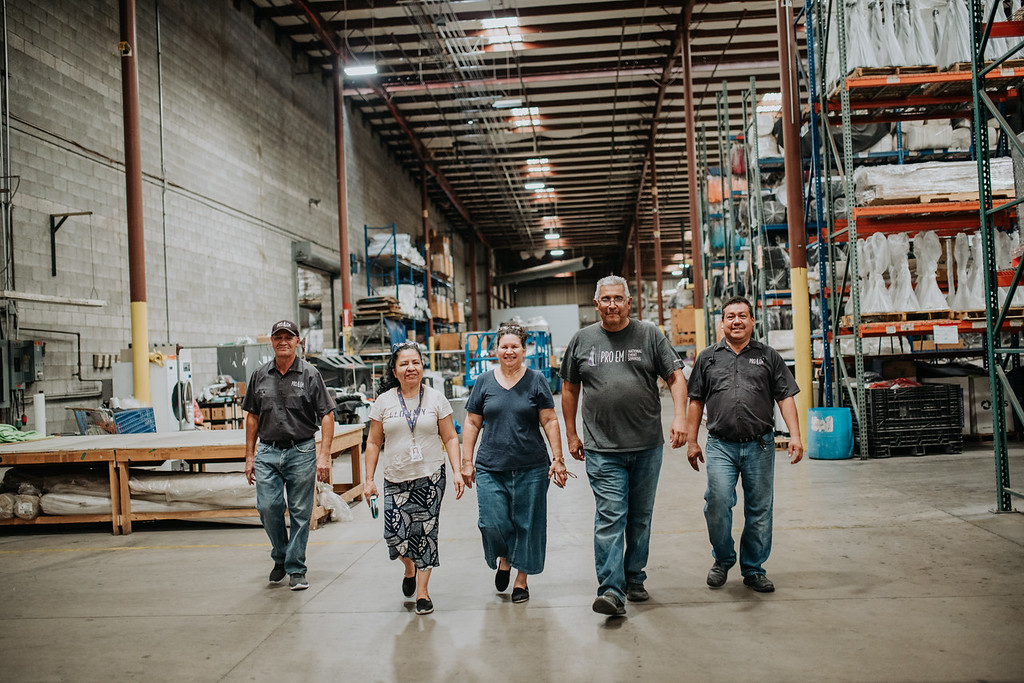 PROEM Team walking together in PROEM warehouse