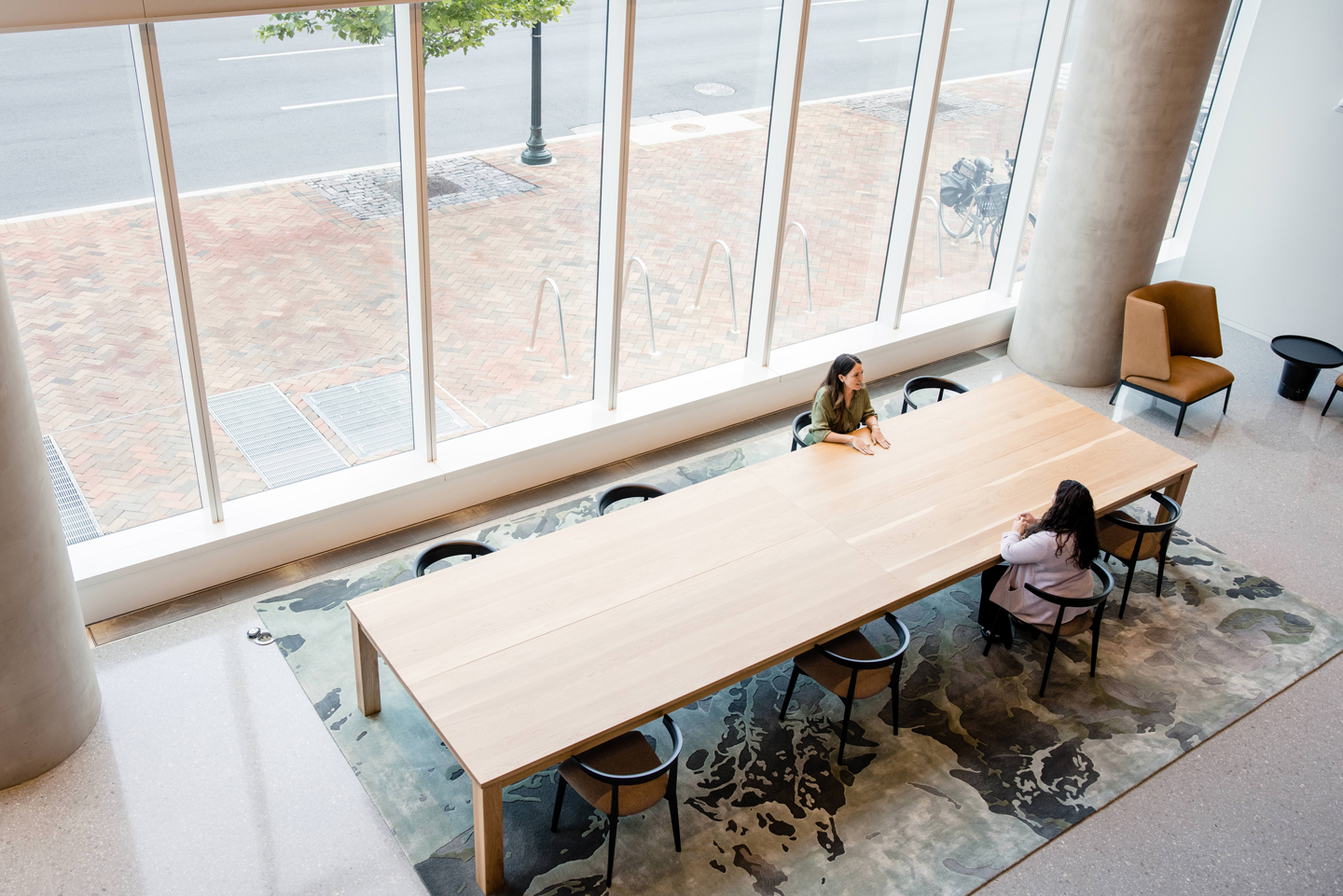 two coworkers sitting in front of long table