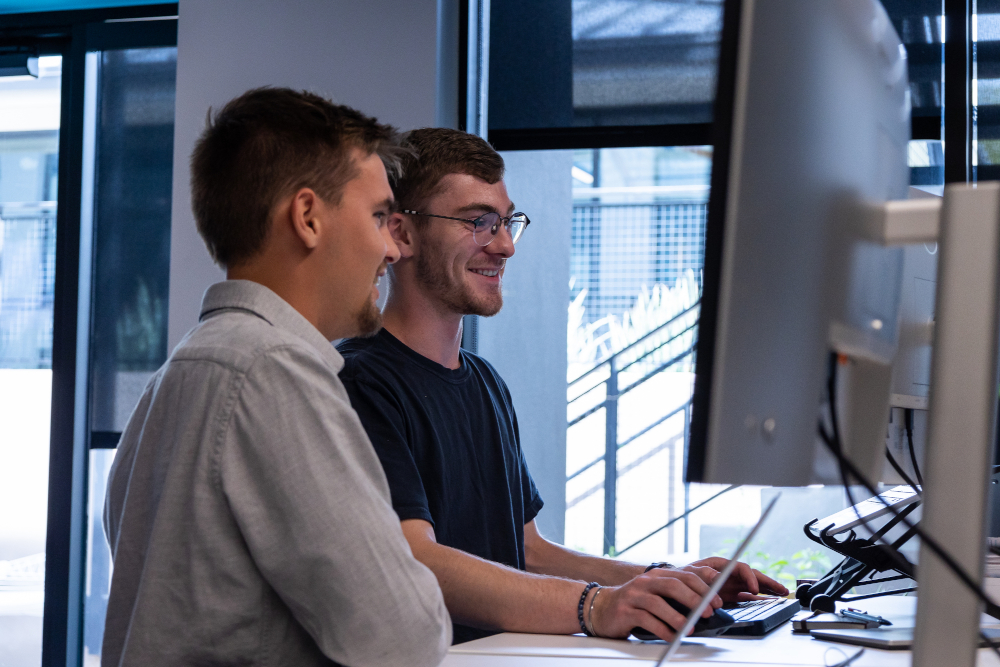 two men looking at a computer screen